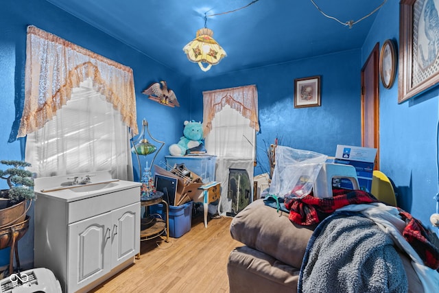 bedroom featuring sink and light hardwood / wood-style flooring