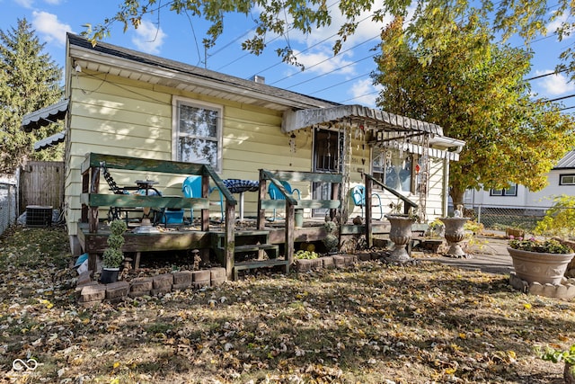 back of house featuring a wooden deck and central AC unit