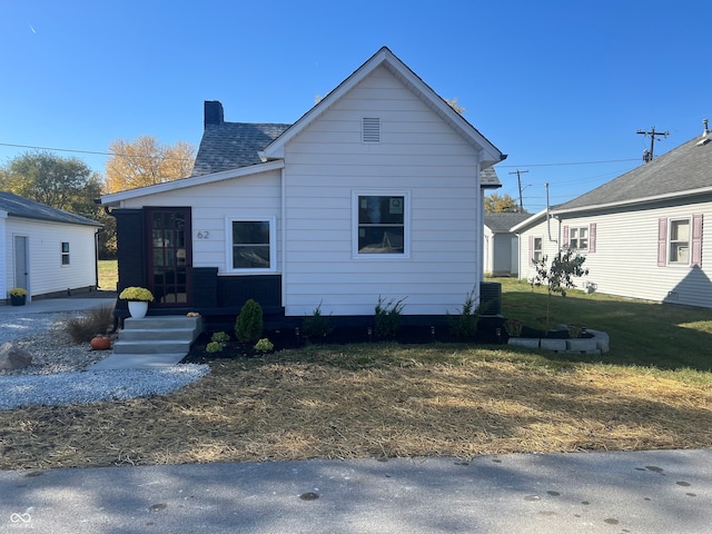 bungalow-style house featuring a front yard