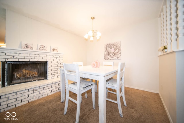 dining space with a brick fireplace, an inviting chandelier, and carpet