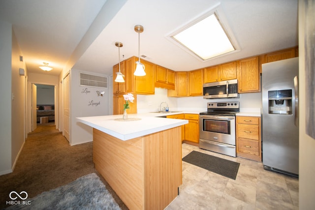 kitchen with stainless steel appliances, light carpet, a kitchen bar, pendant lighting, and sink