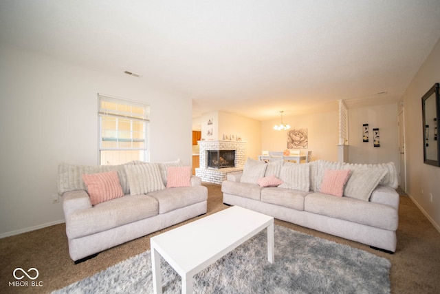 carpeted living room featuring a chandelier and a fireplace