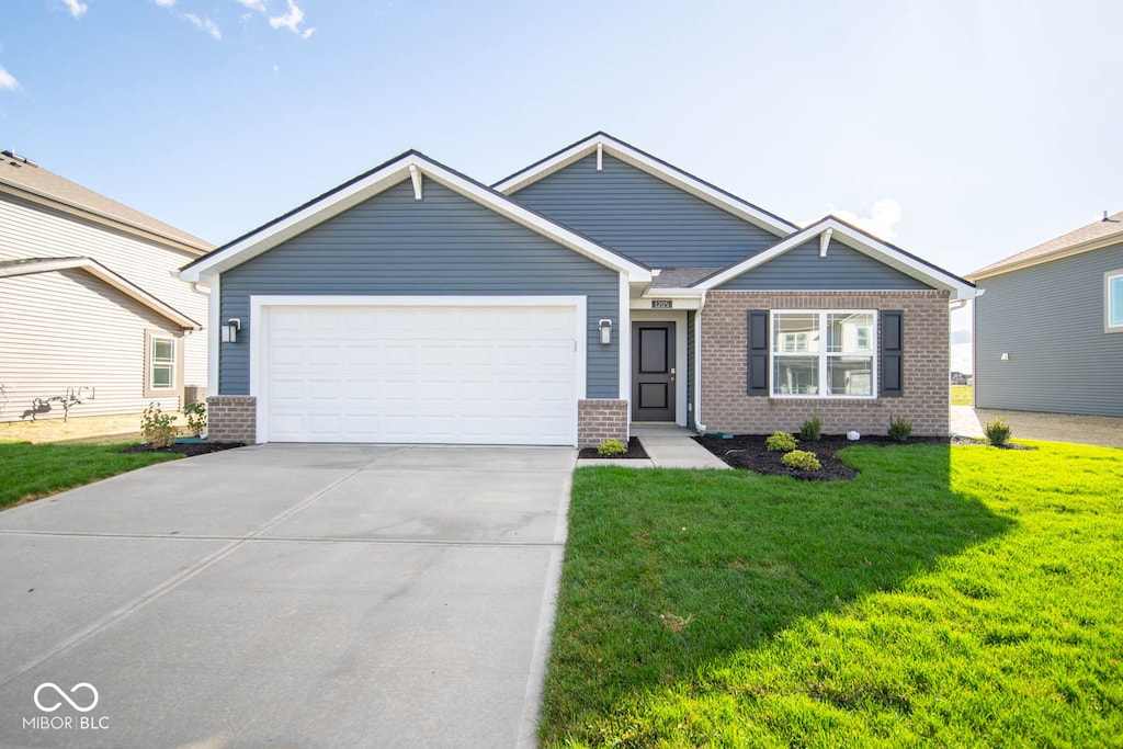 view of front of house with a front yard and a garage