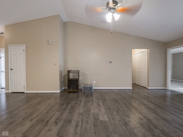 unfurnished living room featuring dark wood-type flooring, ceiling fan, and vaulted ceiling