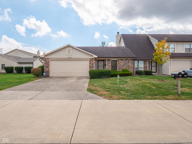 view of front of house with a front yard and a garage