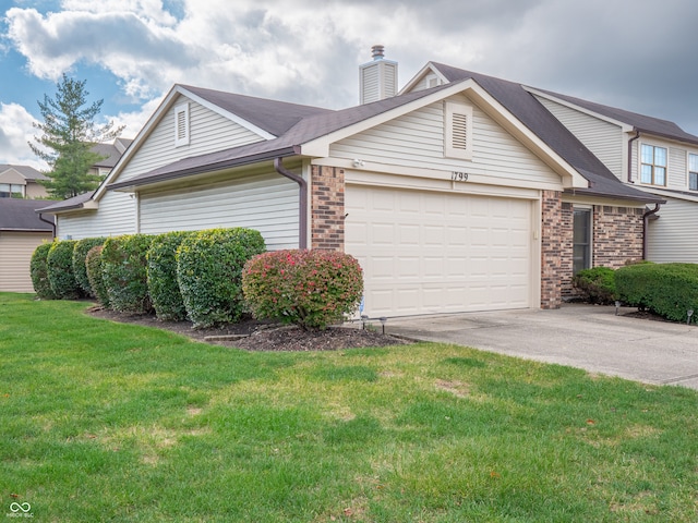 view of front of property featuring a garage and a front yard