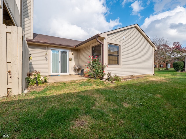 back of house with a yard and a patio area