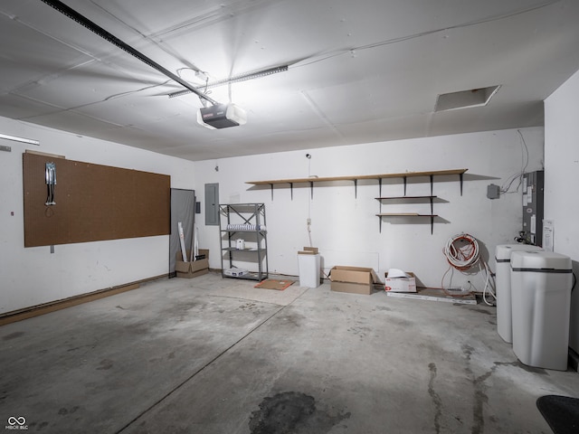 garage featuring electric panel and a garage door opener