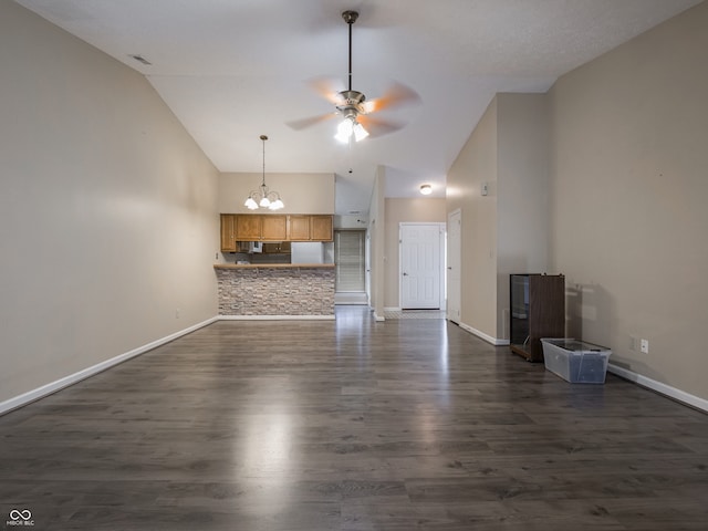 unfurnished living room with dark wood-type flooring, high vaulted ceiling, and ceiling fan with notable chandelier