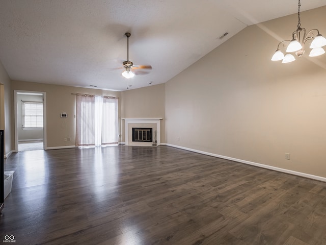 unfurnished living room featuring ceiling fan with notable chandelier, dark wood-type flooring, a textured ceiling, and lofted ceiling