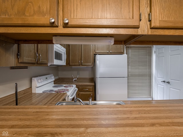 kitchen with white appliances and sink