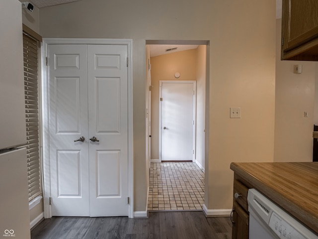 interior space with dark wood-type flooring and vaulted ceiling