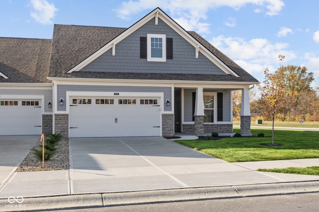 craftsman-style home featuring a garage and a front yard