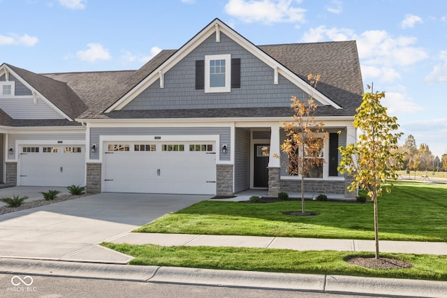 craftsman inspired home featuring a garage and a front yard