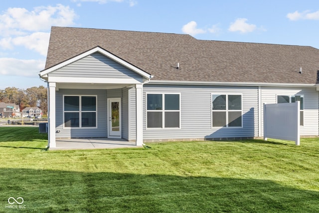 back of property with a patio area and a lawn