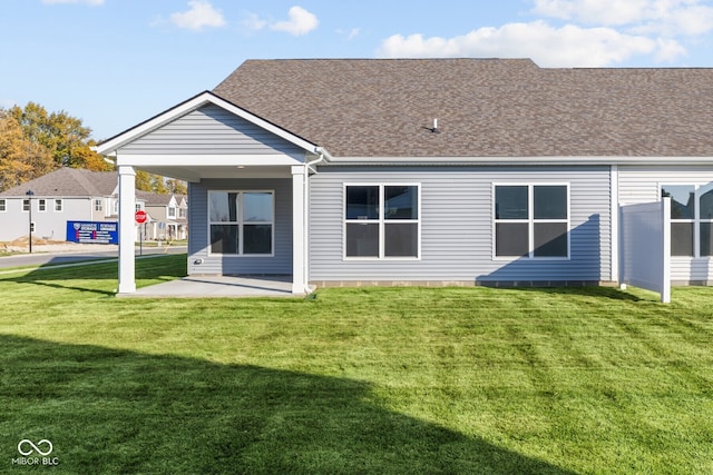 rear view of house with a lawn