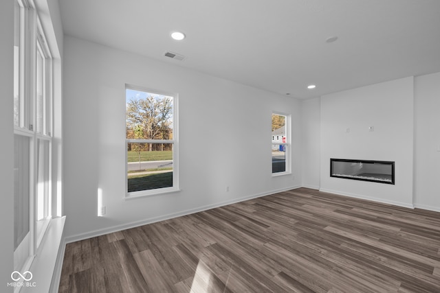 unfurnished living room with dark wood-type flooring