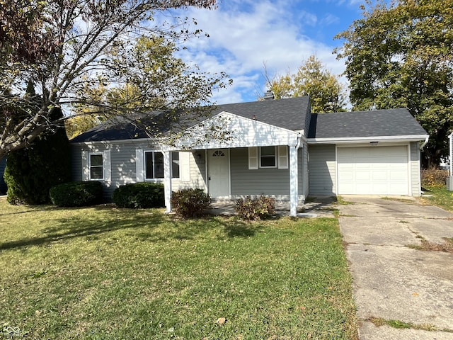 ranch-style home featuring a garage and a front lawn