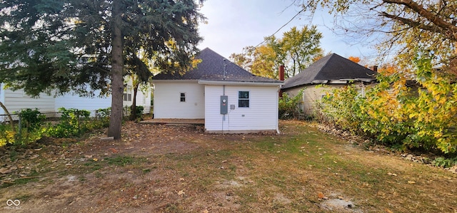 back of property featuring a lawn