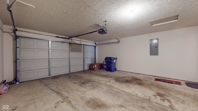 garage with a garage door opener and electric panel