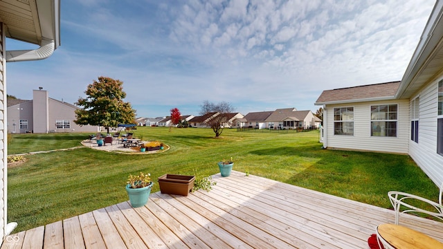 wooden deck with a patio area and a lawn