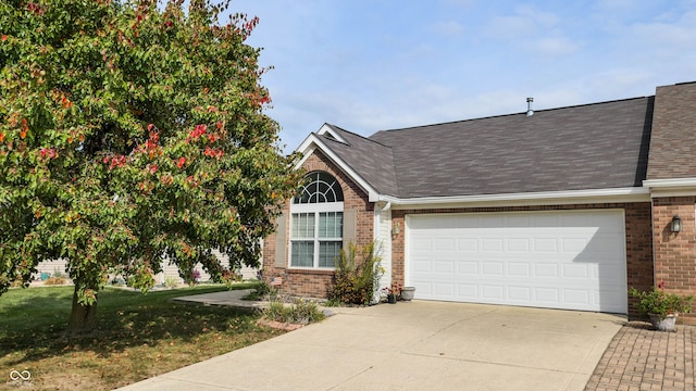 view of front of property with a front yard and a garage