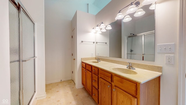 bathroom featuring vanity and an enclosed shower