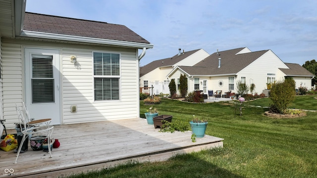 back of house with a wooden deck and a lawn