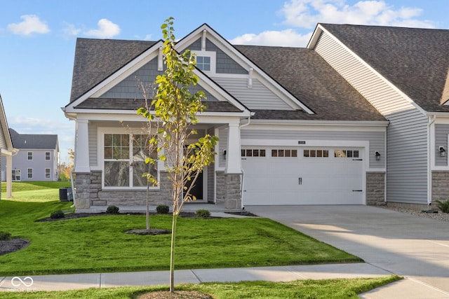 10549 Maidenhair Dr, Indianapolis, IN 46239 - craftsman-style home featuring stone siding, an attached garage, and a front lawn