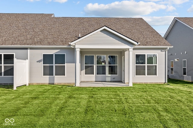 rear view of house with a patio area and a yard