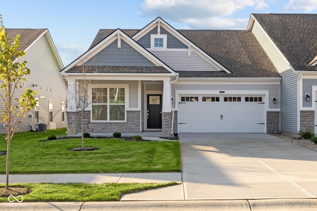 10549 Maidenhair Dr, Indianapolis, IN 46239 - craftsman inspired home featuring an attached garage, stone siding, concrete driveway, and a front lawn