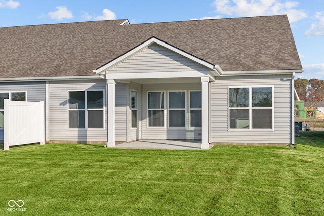 back of property featuring a patio and a lawn