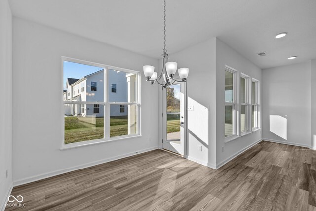 10549 Maidenhair Dr, Indianapolis, IN 46239 - unfurnished dining area with a chandelier, wood finished floors, baseboards, and recessed lighting