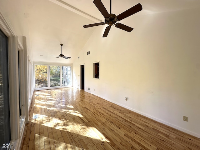 unfurnished living room with hardwood / wood-style flooring, high vaulted ceiling, and ceiling fan