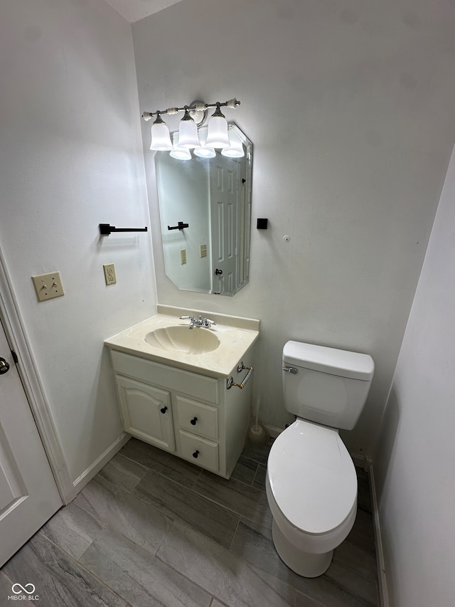 bathroom with vanity, hardwood / wood-style floors, and toilet