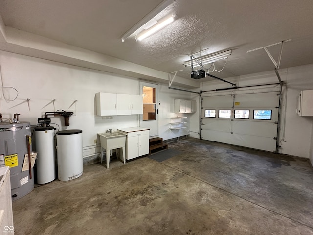 garage featuring sink, electric water heater, and a garage door opener