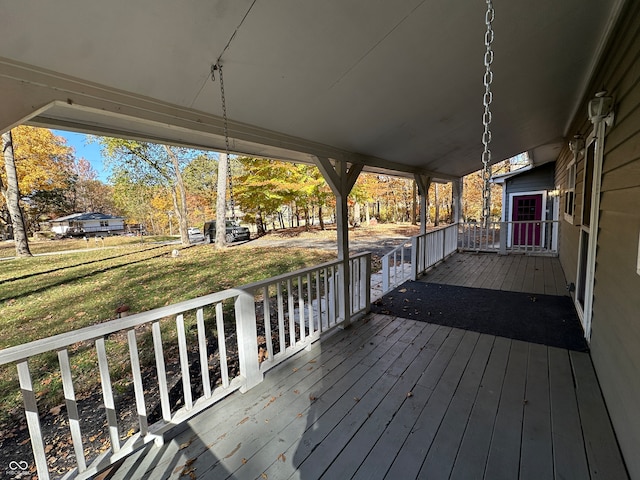 deck featuring a porch and a lawn