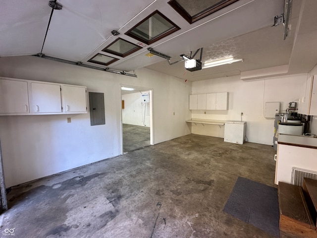 garage with a garage door opener and electric panel