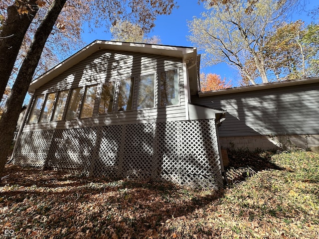 view of side of home featuring a sunroom