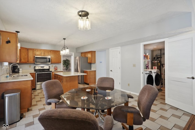 dining room with a textured ceiling, sink, and washer and clothes dryer