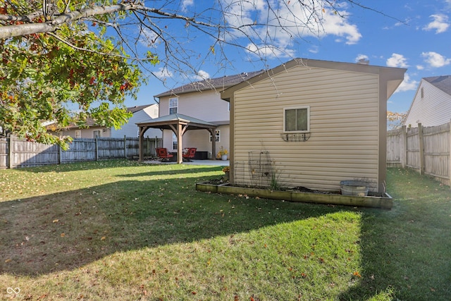 back of house with a gazebo, a yard, and a patio