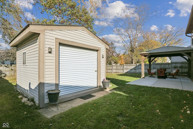 exterior space featuring a gazebo, an outbuilding, and a patio