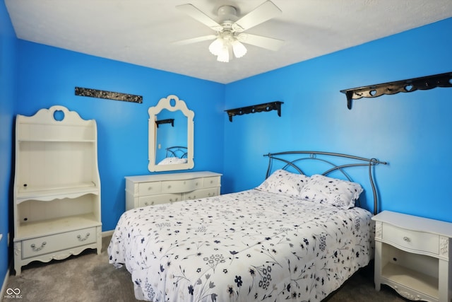 bedroom featuring ceiling fan and dark colored carpet