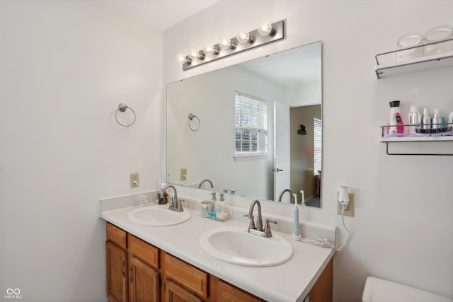 bathroom featuring vanity and toilet