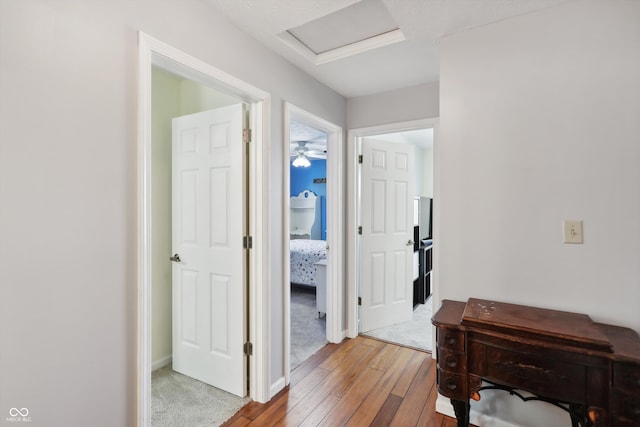 hallway with hardwood / wood-style flooring