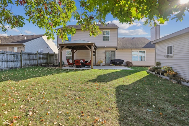 back of house featuring a gazebo, a patio, and a lawn