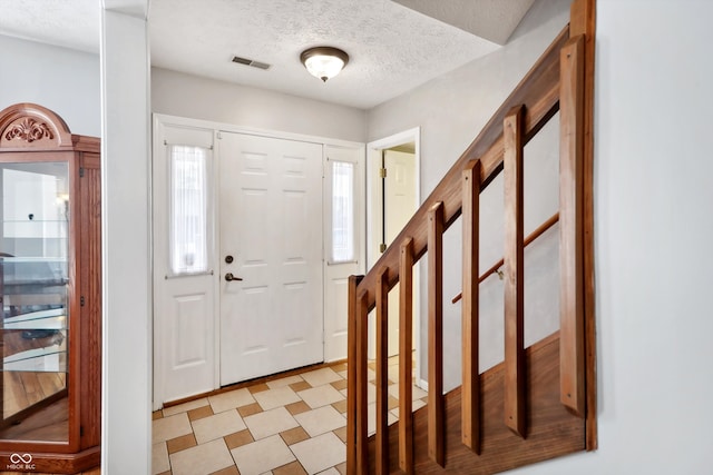 entryway with a textured ceiling