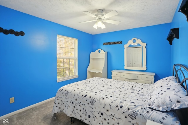 bedroom with ceiling fan, carpet flooring, and a textured ceiling