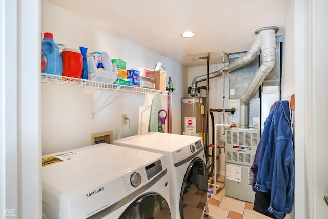 washroom featuring water heater and separate washer and dryer