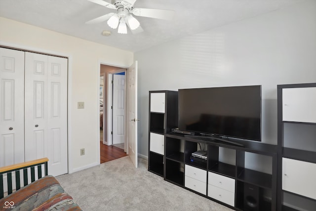 living room with light colored carpet and ceiling fan